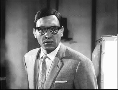 Man In Glasses And Suit Looking At Camera GIF