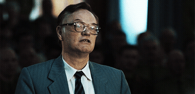 Man In Glasses And Suit Looking At Camera GIF