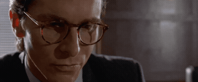 Man In Glasses And Suit Looking At Camera GIF