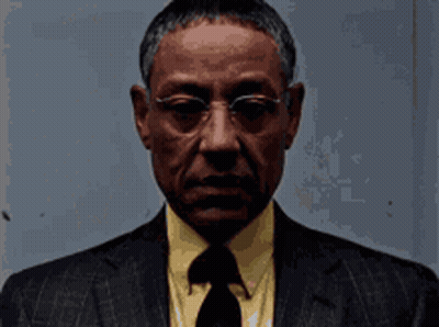 Man In Glasses And Suit Looking At Camera GIF