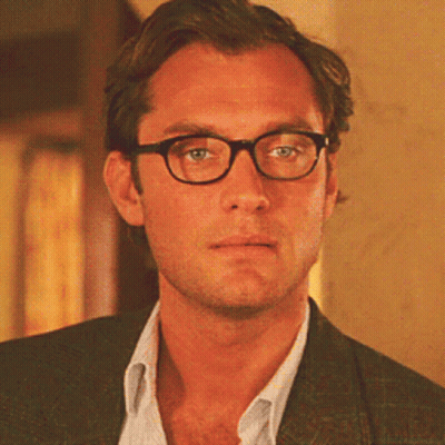 Man In Glasses And Suit Looking At Camera GIF