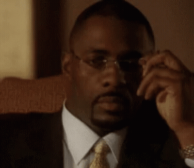 Man In Glasses And Suit Sitting In Chair GIF