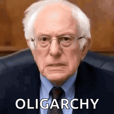 Man In Glasses And Suit Sitting With Oligarchy GIF
