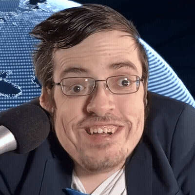 Man In Glasses And Suit Smiling At Microphone GIF
