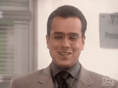 Man In Glasses And Suit Smiling By Nuestra Tele Sign GIF