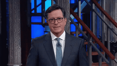 Man In Glasses And Suit Standing In Front Of Stairs GIF