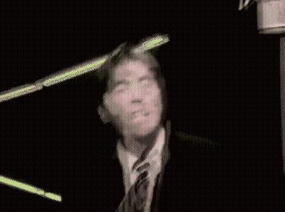 Man In Glasses And Tie Looking At Camera GIF