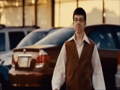 Man In Glasses And Vest In Parking Lot GIF