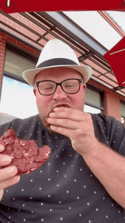 Man In Glasses And White Hat Eating Cookie GIF