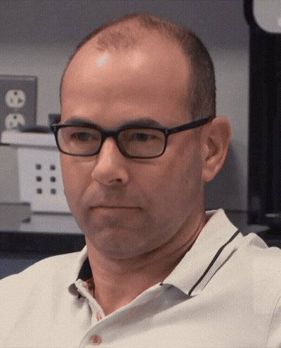Man In Glasses And White Shirt Looking At Camera GIF
