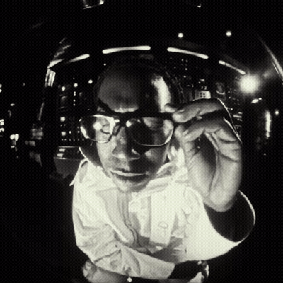 Man In Glasses And White Shirt Looking At Camera GIF