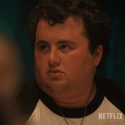 Man In Glasses And White Shirt On Table In Dark GIF