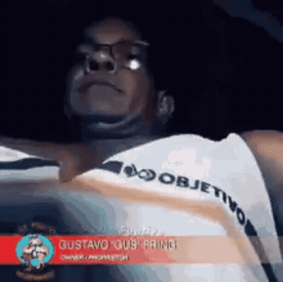 Man In Glasses And White Shirt With Objetivo On Sleeve GIF