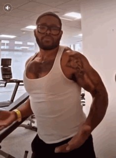 Man In Glasses And White Tank Top In Gym GIF