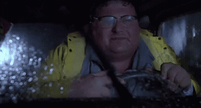 Man In Glasses And Yellow Jacket Driving In Rain GIF