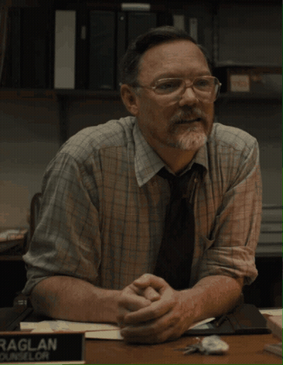 Man In Glasses At Desk With Raglan Sign GIF