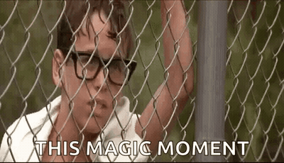 Man In Glasses Behind Chain Link Fence Saying This Magic Moment GIF