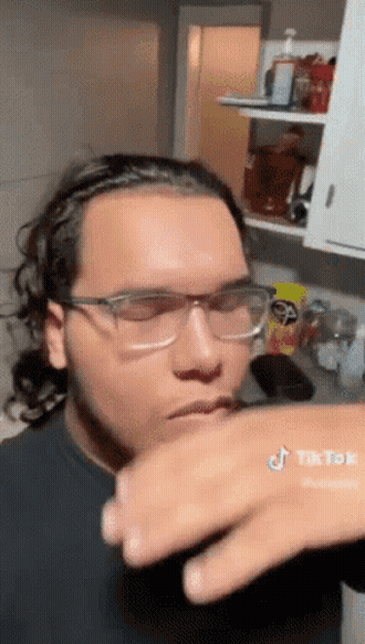 Man In Glasses Hand On Mouth In Kitchen GIF