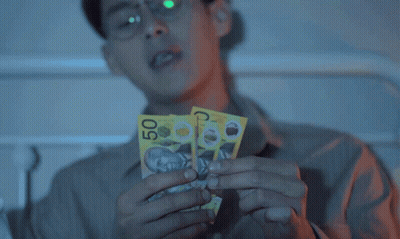 Man In Glasses Holding Two Pill Packets GIF