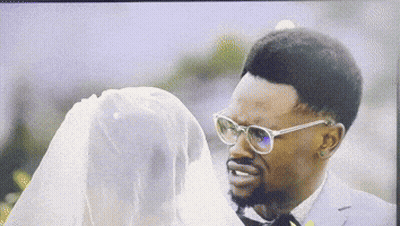 Man In Glasses Looking At Woman In White Dress GIF