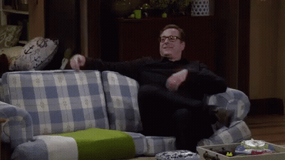 Man In Glasses On Blue Plaid Couch GIF