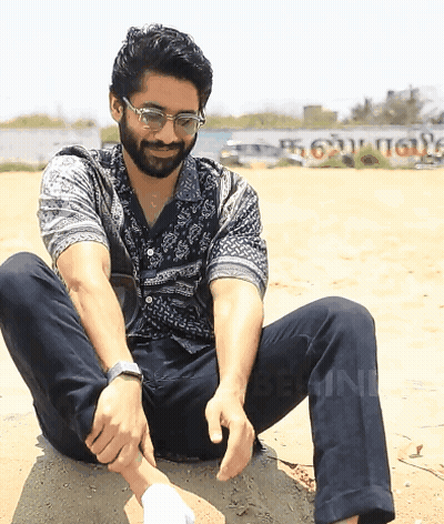 Man In Glasses On Rock With Tamil Sign GIF