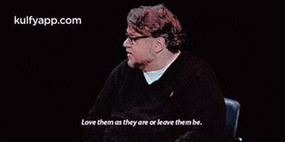 Man In Glasses Sitting In Chair Saying Love Them As They Are Or Leave Them Be GIF