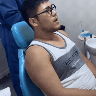 Man In Glasses Sitting In Dental Chair GIF