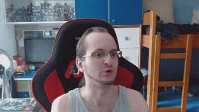 Man In Glasses Sitting In Red And Black Chair GIF