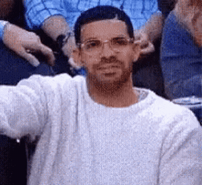 Man In Glasses Taking Selfie In Crowd GIF