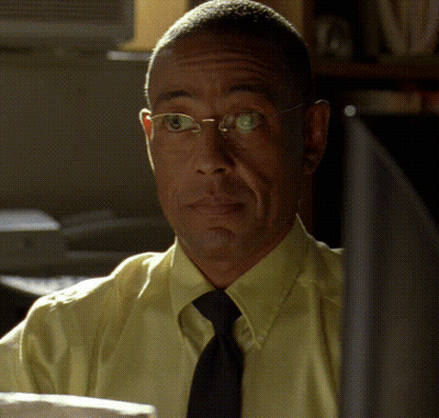 Man In Glasses Yellow Shirt And Tie Looking At Camera GIF
