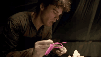 Man In Gloves Holding Pink Object GIF