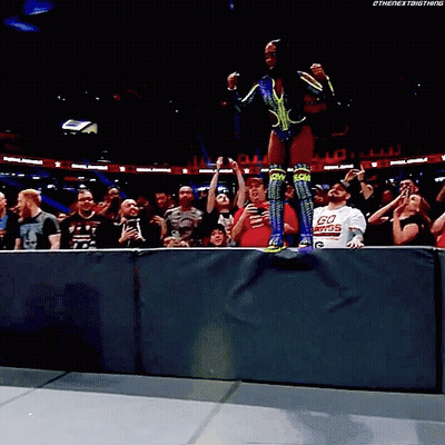 Man In Go Power Shirt In Front Of Crowd GIF