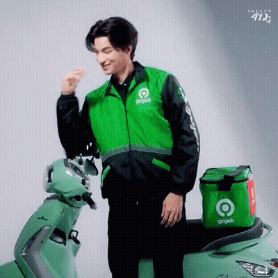 Man In Gojek Jacket Next To Green Scooter GIF