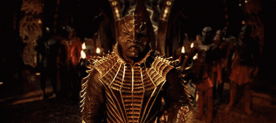 Man In Gold Costume Standing In Front Of Crowd GIF