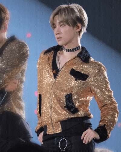 Man In Gold Jacket And Choker On Stage GIF