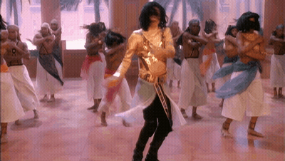 Man In Gold Outfit Dancing With Dancers GIF