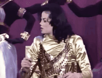 Man In Gold Shirt With Group GIF