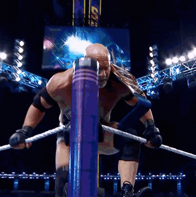 Man In Goldberg Shirt In Front Of WWE Hall Of Fame Sign GIF