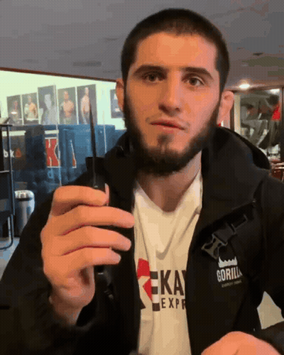 Man In Gorilla Express Jacket Holding Cell Phone GIF