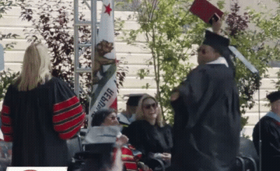Man In Graduation Cap And Gown Holding Diploma GIF