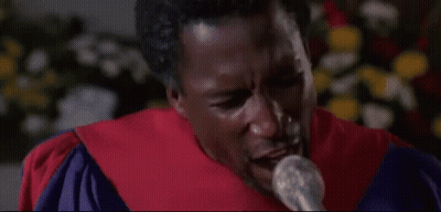 Man In Graduation Cap And Gown Singing Into Microphone Eyes Closed GIF