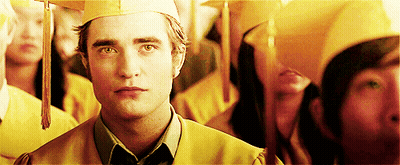 Man In Graduation Cap And Gown Standing In Crowd GIF