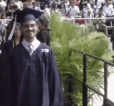 Man In Graduation Cap And Gown With FIU Shirt GIF