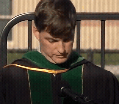 Man In Graduation Cap Speaking Into Microphone GIF