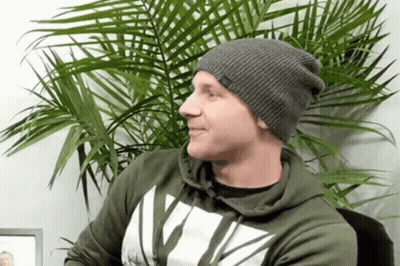 Man In Gray Beanie And Green Hoodie With Letter V GIF