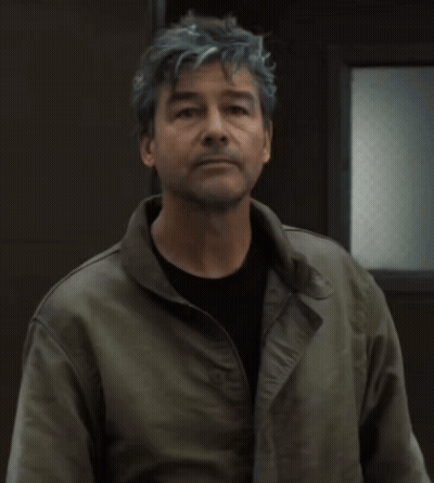 Man In Gray Hair And Black Shirt Wearing Green Jacket GIF