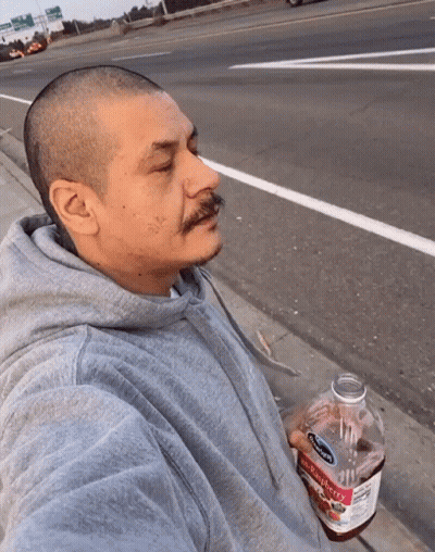 Man In Gray Hoodie Holding Strawberry Juice GIF