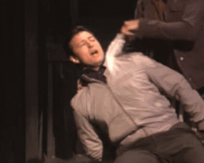Man In Gray Jacket Lying On Floor GIF