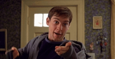 Man In Gray Jacket Pointing At Camera GIF